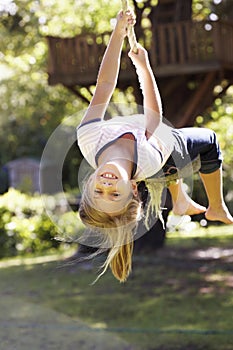 Young Girl Having Fun On Rope Swing