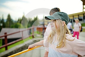 Young girl having fun on a walk on Gubalowka mountain range. High Tatra mountains and green hills in summer or spring