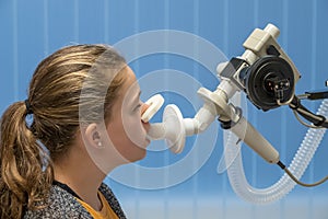 A young girl having a lung function test