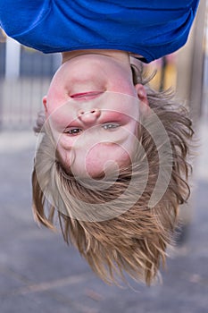 Young girl head hanging upside down