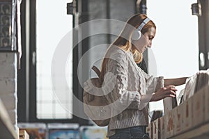 Young girl browsing vinyl records in a music store