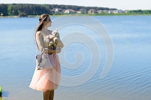 Young girl with her dog. Puppy white dog is running with it`s owner. Concept about friendship, animal and freedom