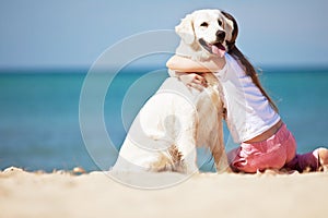 Young girl with her dog by seaside