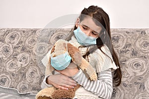 Young girl and her dog toy with medical protective face masks