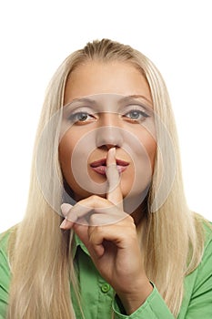 Young girl with her finger over her mouth