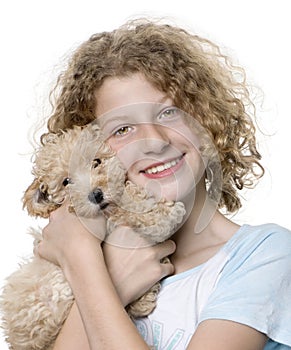 Young girl with her toy Poodle puppy (9 weeks old)