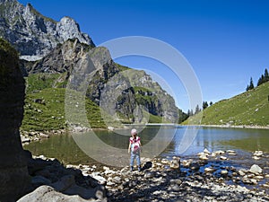 Young girl hiking around Bannalpsee in Switzerland