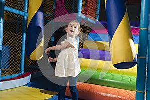 Young girl hitting foam object in play gym