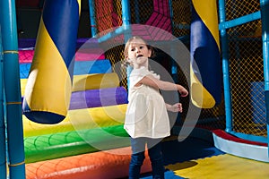 Young girl hitting foam object in play gym