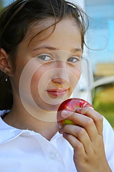 Young girl holding apple