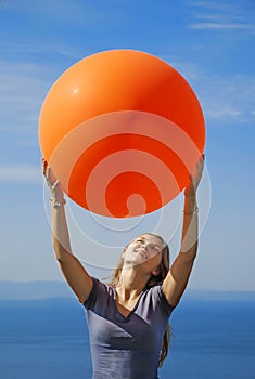 A girl holding big balloon