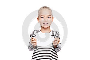 Young girl holding blank card infront of her. Speech therapy concept on white background. Correct pronounciation and articulation.