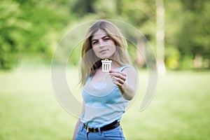 Young girl holding cardboard bin icon