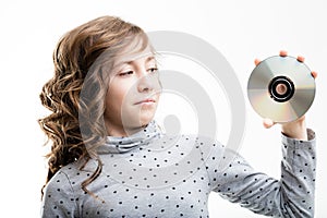 Young girl holding CD-ROM disk