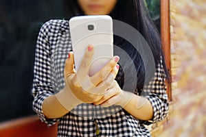 young girl holding cellphone, technology or social network concept