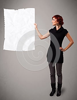 Young girl holding crumpled white paper copy space