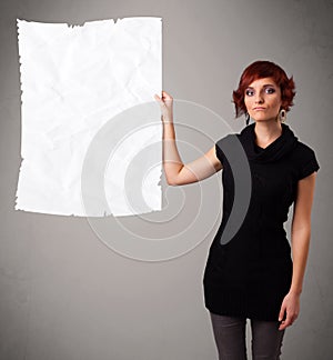 Young girl holding crumpled white paper copy space