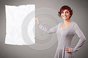 Young girl holding crumpled white paper copy space