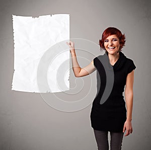 Young girl holding crumpled white paper copy space