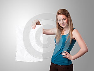 Young girl holding crumpled white paper copy space