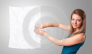 Young girl holding crumpled white paper copy space