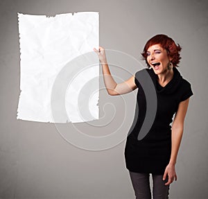 Young girl holding crumpled white paper copy space