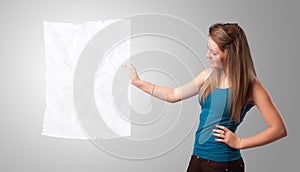 Young girl holding crumpled white paper copy space