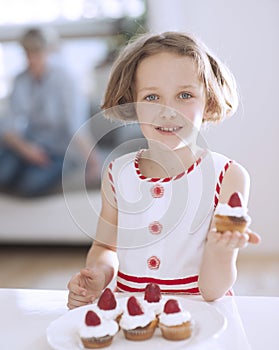 Young girl holding cup cake