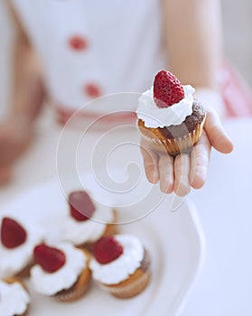 Young girl holding cup cake