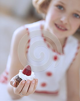 Young girl holding cup cake