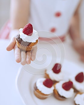 Young girl holding cup cake