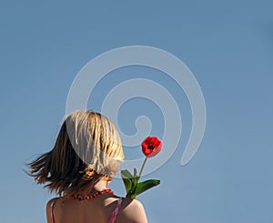 Young girl holding flower