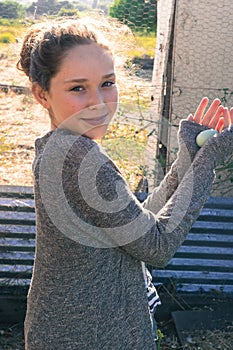 Young Girl Holding Fresh Farm Egg
