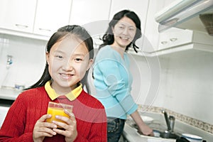 Young Girl Holding Glass of Orange Juice