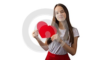 A young girl holding a heart