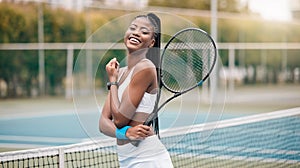 Young girl holding her tennis racket on the court. Portrait of a happy player ready for tennis practice. African