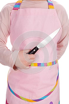 Young girl holding kitchen knife.