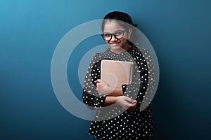 Young girl holding note books in her hand