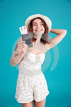 Young girl holding passport and travelling tickets