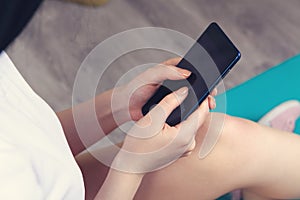 A young girl holding a phone in her hands