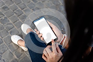 Young girl holding phone new app technology in the city