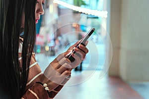 Young girl holding phone new app technology in the city