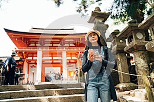 Young girl holding phone online guide book