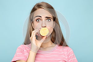 Young girl holding piece of lemon