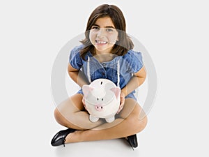 Young girl holding a piggybank