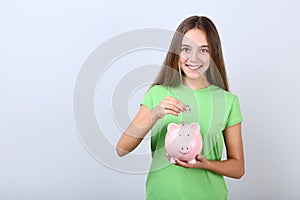 Girl holding pink piggybank