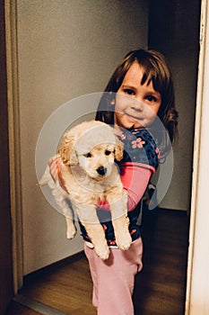 Young girl holding puppy