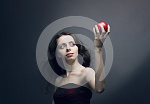 Young girl holding a red apple