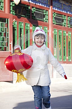 Young girl holding red lantern