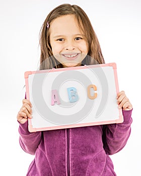 Young girl holding sign with ABC